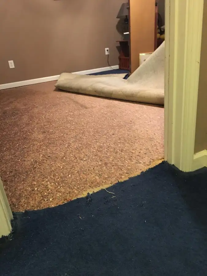 Carpet pad removal revealing water damage during Drying & Dehumidification in Guthrie